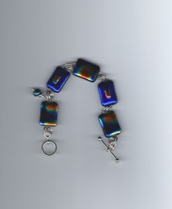 The different colors in the Dichroic glass are amazing! I make the beads, then join them with sterling silver double jump rings & finish with silver toggles.  $85