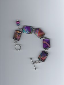 Softer colors in this bracelet but still has the reflective qualities of Dichroic glass. Blues and lavender...    $85